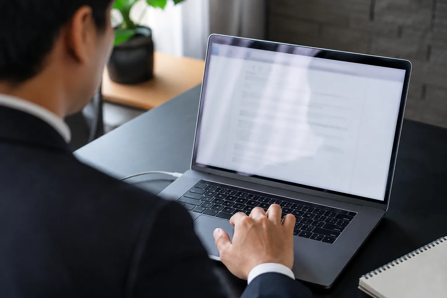 AI-generated editorial image of a law graduate using a laptop with a blurred, generic document screen.